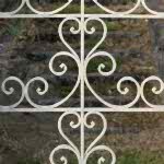 wrought_iron_gate_-_decorative_gate_opens_on_stone_stairs_leading_to_an_abandoned_french_seaside_villa_
